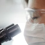 Woman looking under a microscope